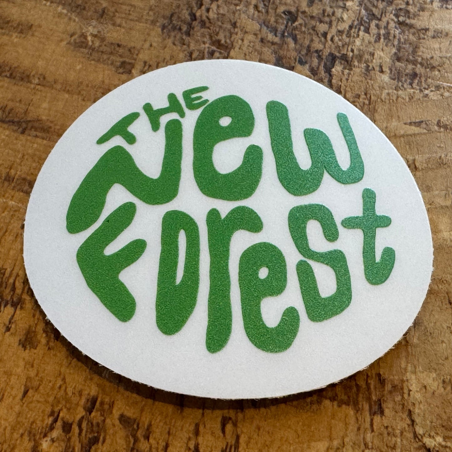 The New Forest Typography Circle Sticker (Clear) Green on Desk