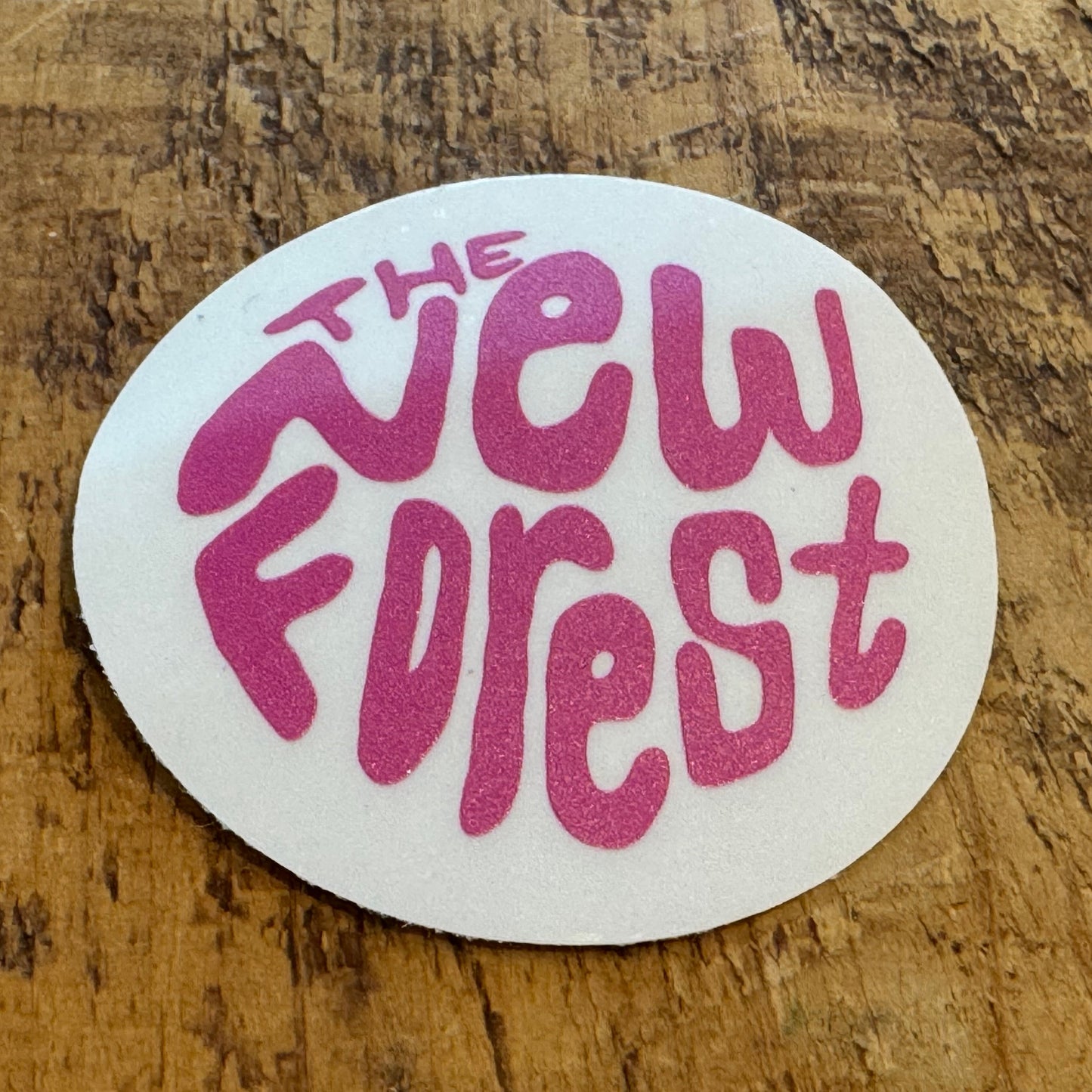 The New Forest Typography Circle Sticker (Clear) Pink on Desk