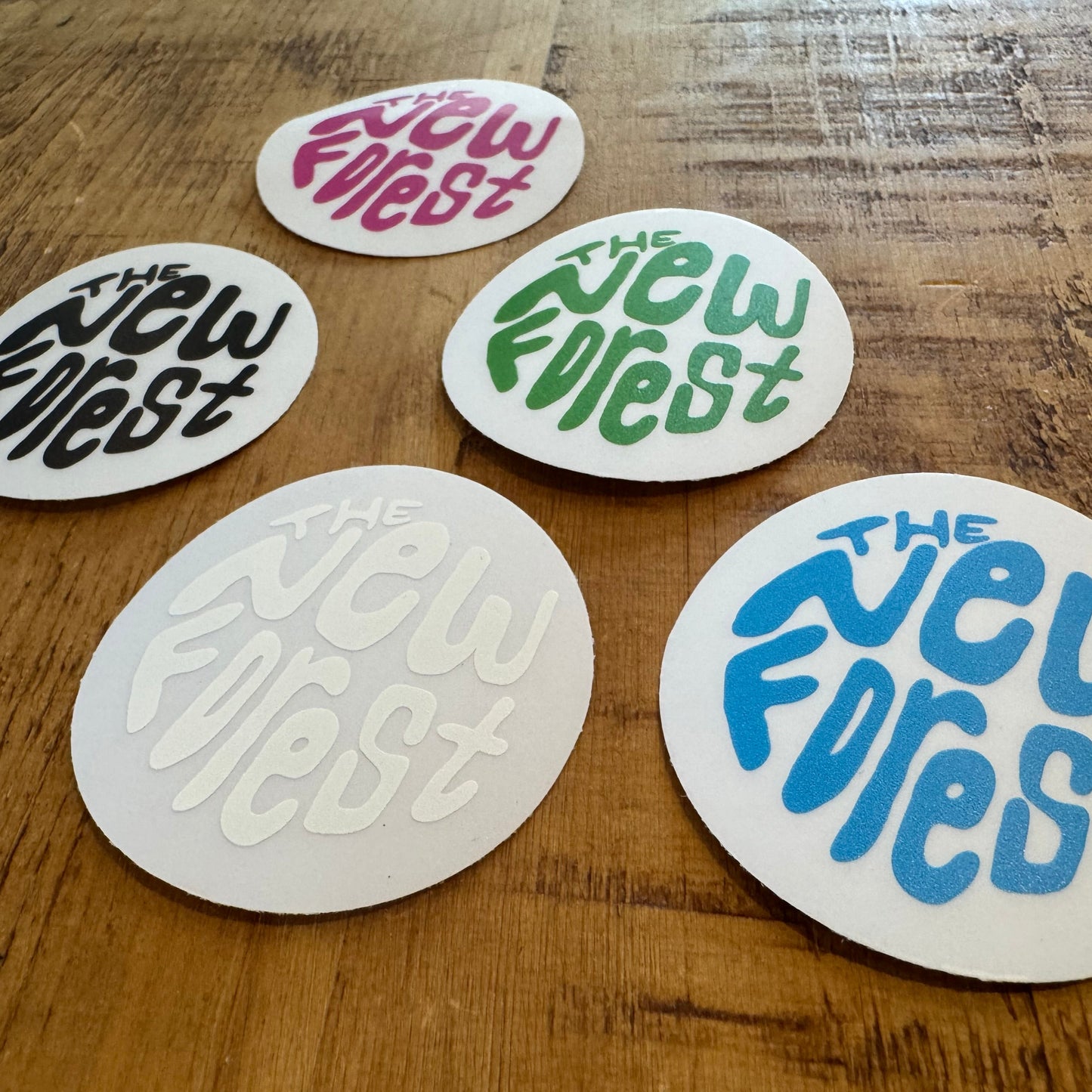 The New Forest Typography Circle Sticker (Clear) Set on Desk