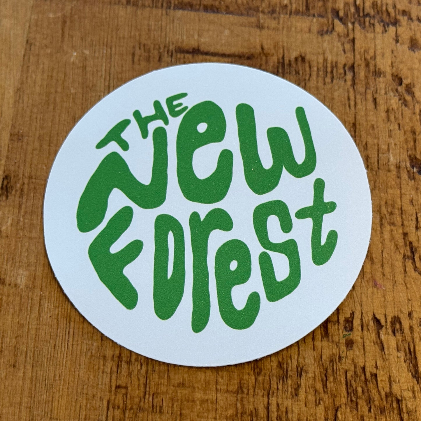 The New Forest Typography Circle Sticker (Solid) Green/White on Desk